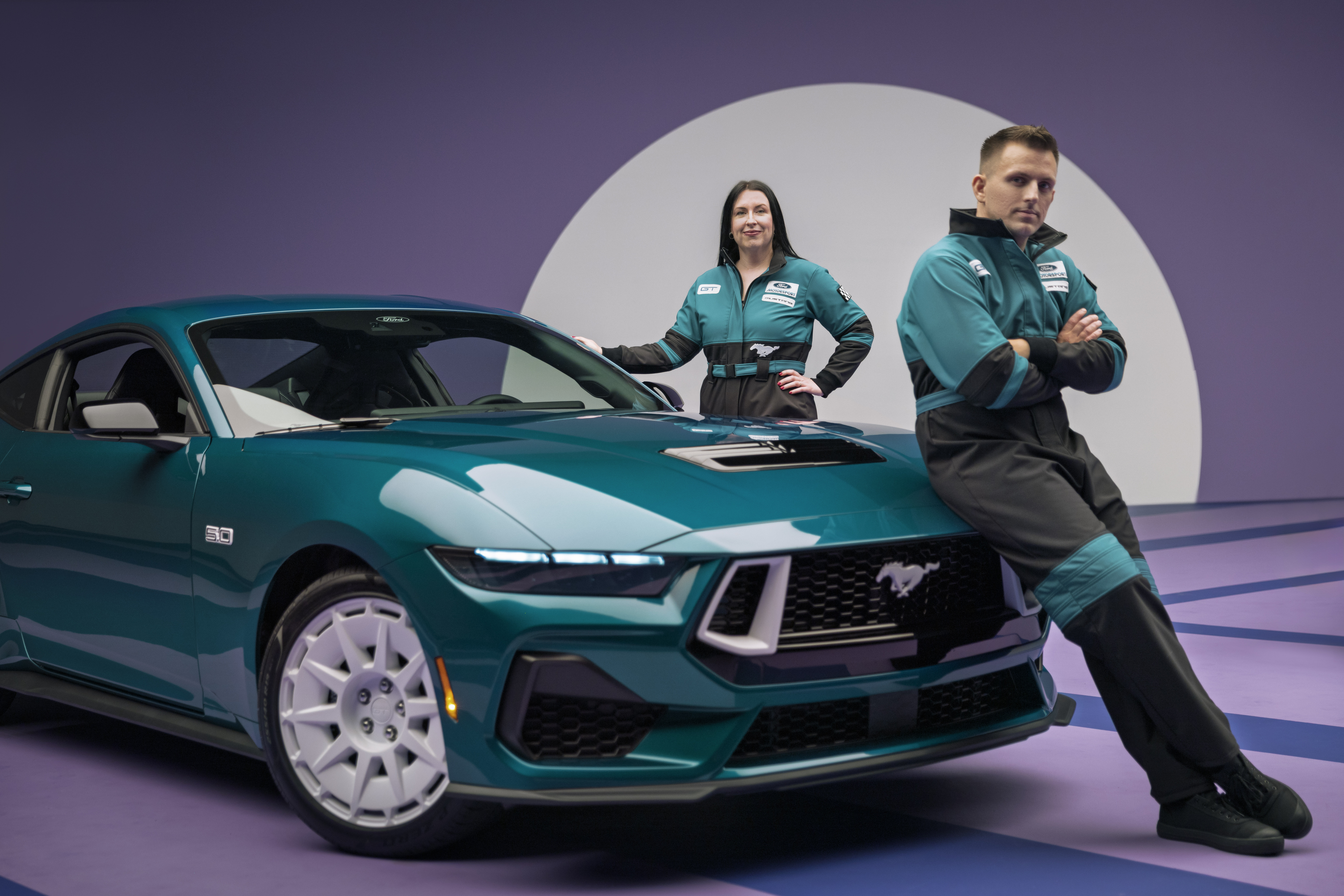 Designers Kristen Keenan and Stefan Taylor alongside the 2026 Mustang FX Package. Preproduction model shown with optional equipment and extra cost color.
